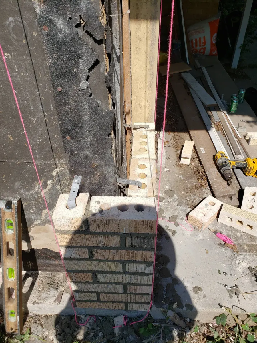 Before: Repaired and rebuilt brick wall corner